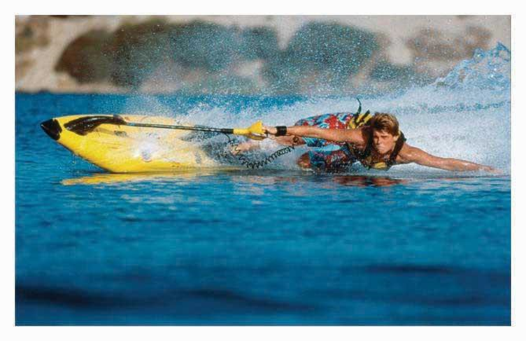 Rider on a yellow board appearing to be skimming the water i.e. parallel to the water.