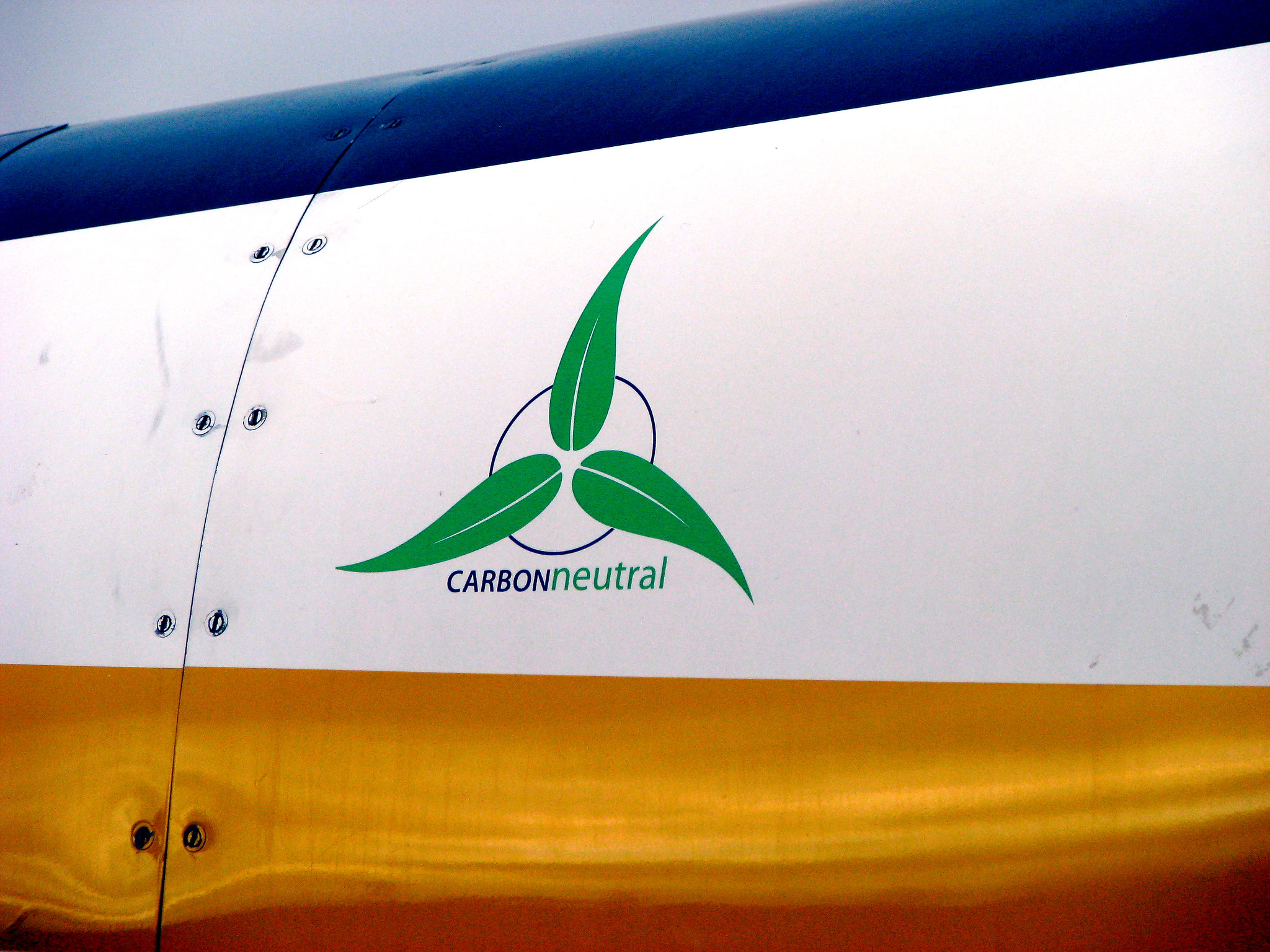 A symbol saying &quot;carbon neutral&quot; on the side of a sea plane.