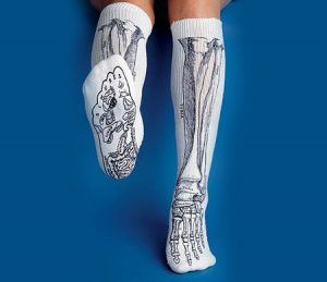 Person wearing matching socks in skeleton patter.