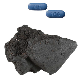 Two blue pills next to a stone like lump of dark grey matter.