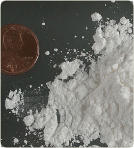 A penny next to powdered cocaine.