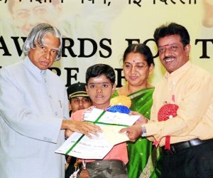 The academic award this boy is receiving may contribute to his sense of industry.