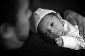 A newborn gazing up at a parent.