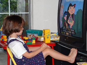 A child watching TV instead of playing.