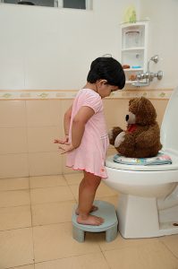 A child learning to be toilet trained.