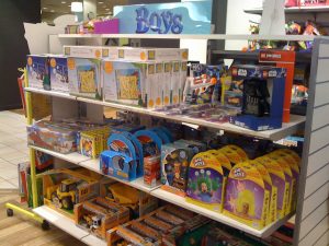 Store shelves filled with primary colors and boys’ toys.