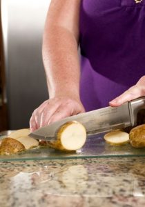Slicing potatoes on a glass cutting board
