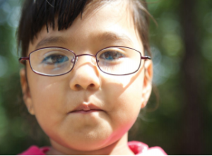 Young girl wearing glasses.