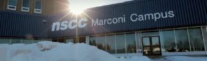 NSCC Marconi Campus on a sunny winter day with large snowbanks around a shovelled path to an entrance door