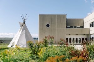 picture of campus with tipi on grass.