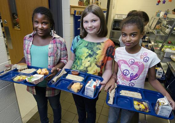 Three students holding lunch trays