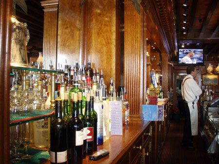 A bar tender standing at the bar.