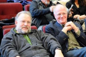 Ben Cohen and Jerry Greenfield, of Ben and Jerry's ice cream fame, casually dressed in the audience of a theatre