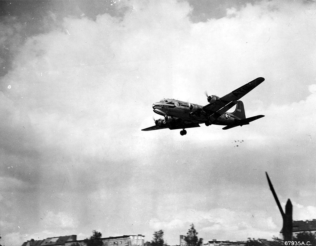 Plane dropping candy while flying low over West Berlin during the airlift.
