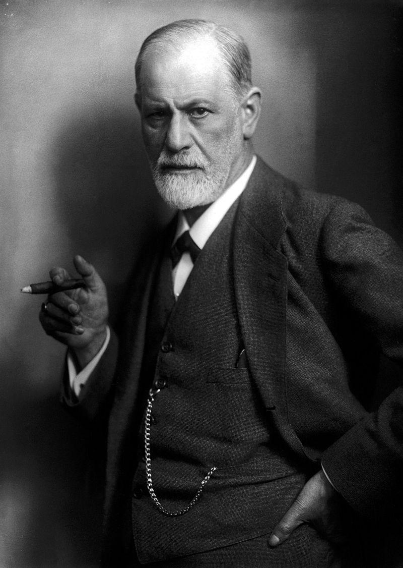 Sigmund Freud in a suit, holding a cigar.