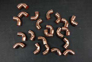 22 copper fittings on a table