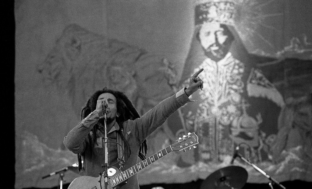 Bob Marley on stage speaking into a microphone