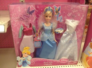 A Cinderella doll with a dress for cleaning, a ball gown, and a wedding dress.