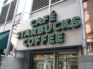 A Starbucks store front with "coffee" spelt in english and french.
