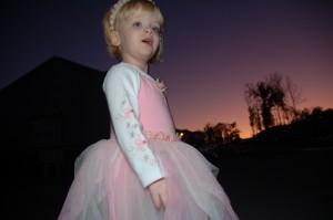 A young girl wearing a pink "princess" dress.