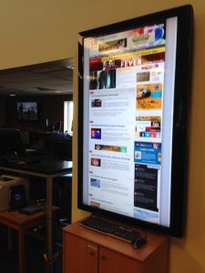 A large digital display of the website is viewable at all times from the newsroom of the hybrid student and professional organization, KOMU at the University of Missouri-Columbia
