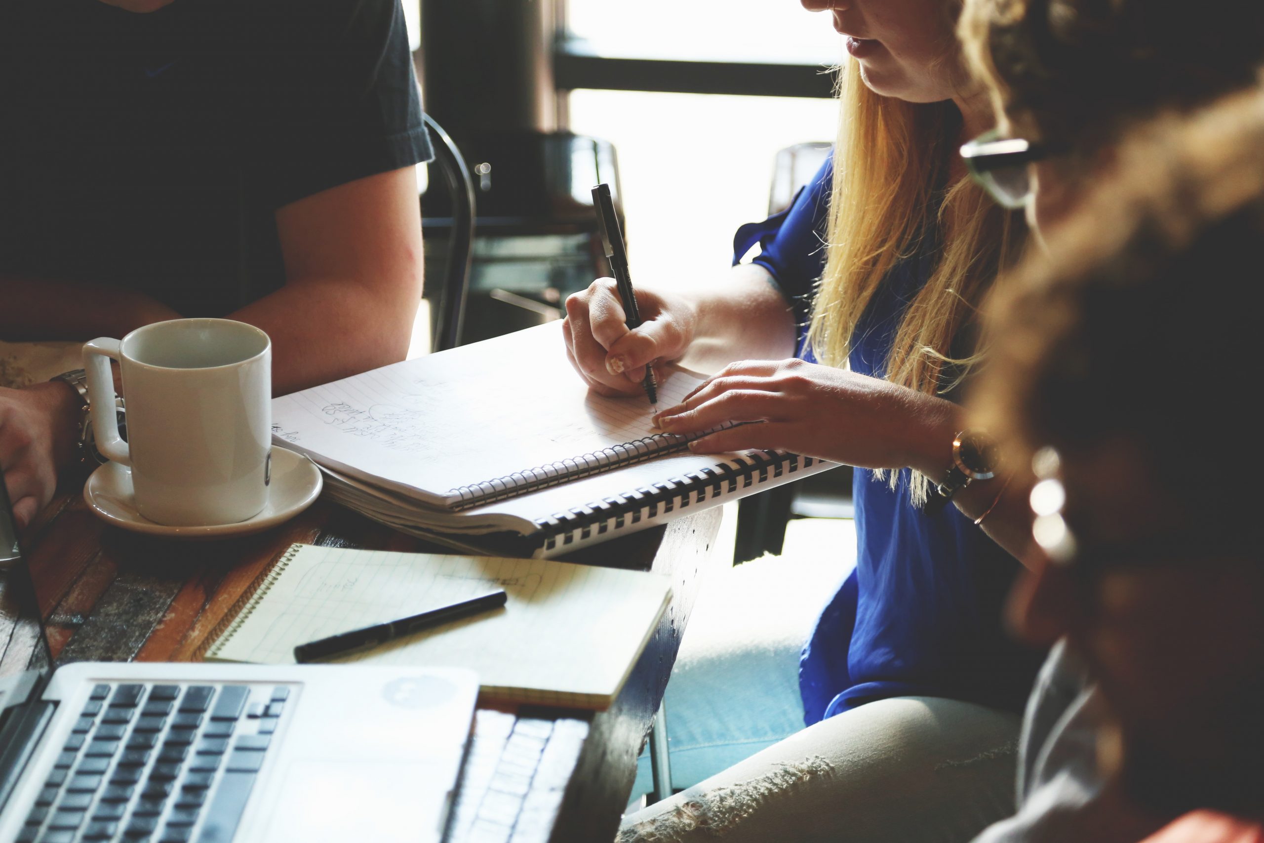 A person writing during a meeting.